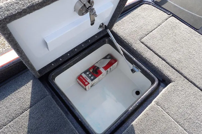 Slide: The Image of Open storage compartment in 2024 Phoenix 721 ProXP boat, featuring a fire extinguisher. - 16