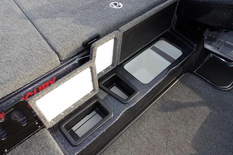 Slide: The Image of 2024 Phoenix 721 ProXP boat interior storage compartments with carpeted finish. - 17