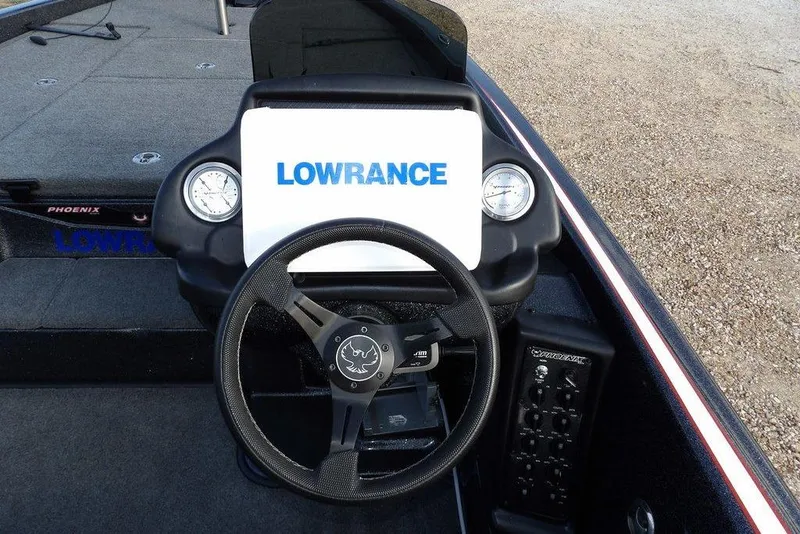 Slide: The Image of 2024 Phoenix 721 ProXP boat dashboard with Lowrance display and steering wheel. - 20