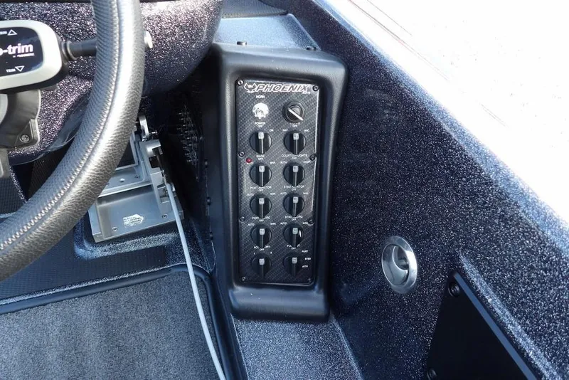 Slide: The Image of 2024 Phoenix 721 ProXP boat dashboard with control panel and steering wheel. - 22