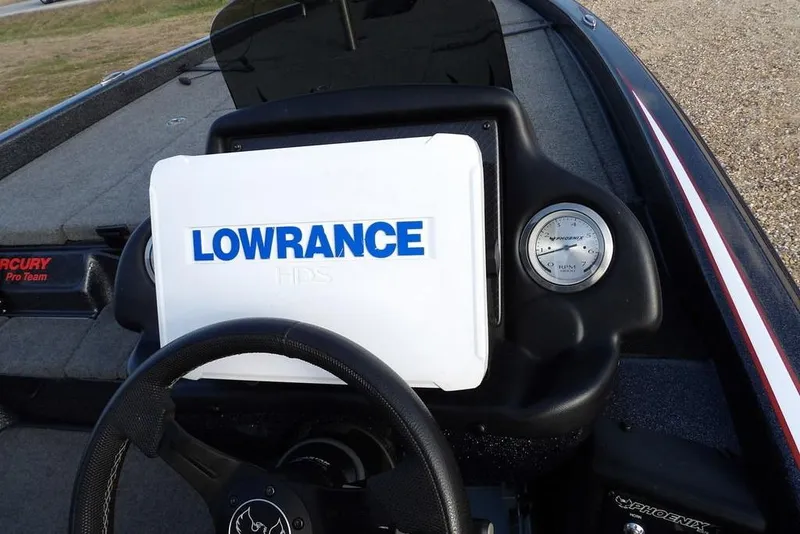 Slide: The Image of 2024 Phoenix 721 ProXP boat dashboard with Lowrance HDS display and steering wheel. - 23