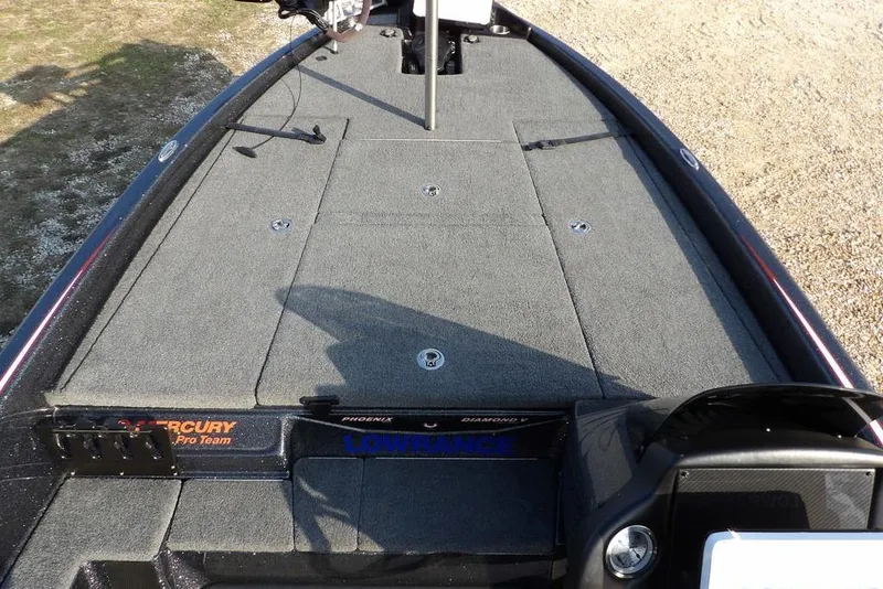 Slide: The Image of 2024 Phoenix 721 ProXP boat deck with carpeted surface and fishing equipment. - 25