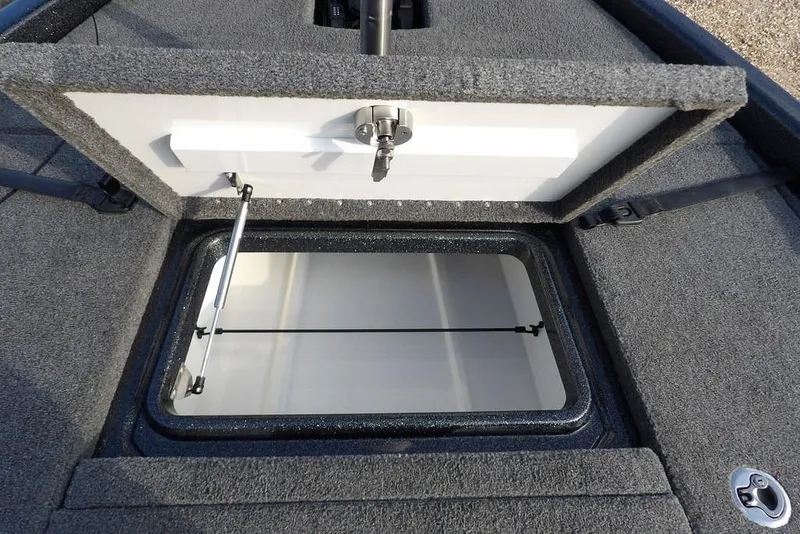 Slide: The Image of 2024 Phoenix 721 ProXP boat storage compartment with open lid and secure latch. - 30