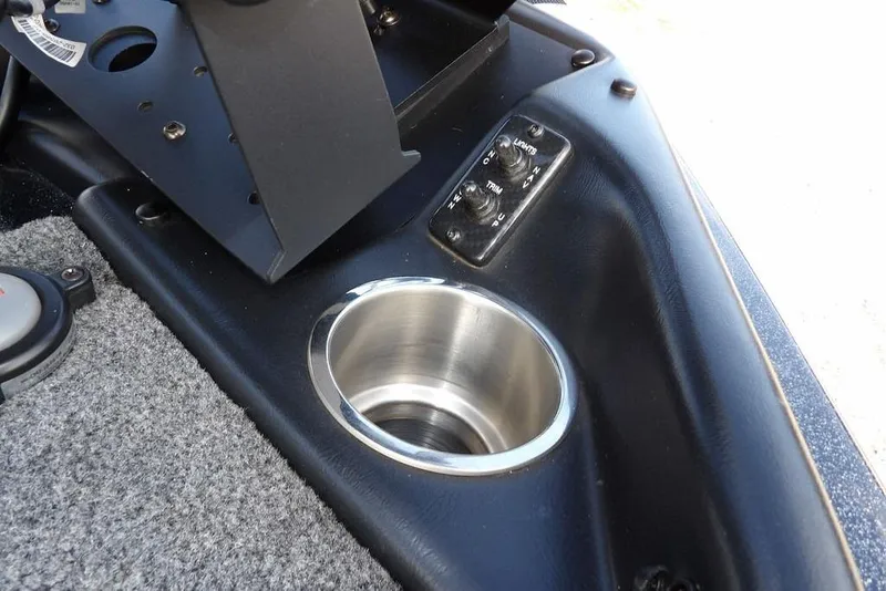 Slide: The Image of 2024 Phoenix 721 ProXP boat console with cup holder and control switches. - 35