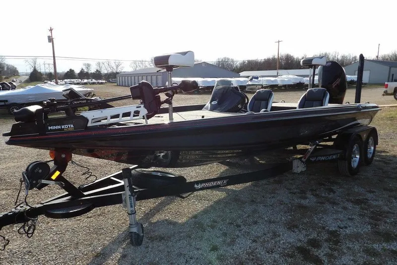 Slide: The Image of 2024 Phoenix 721 ProXP bass boat on trailer, equipped with Minn Kota trolling motor. - 4