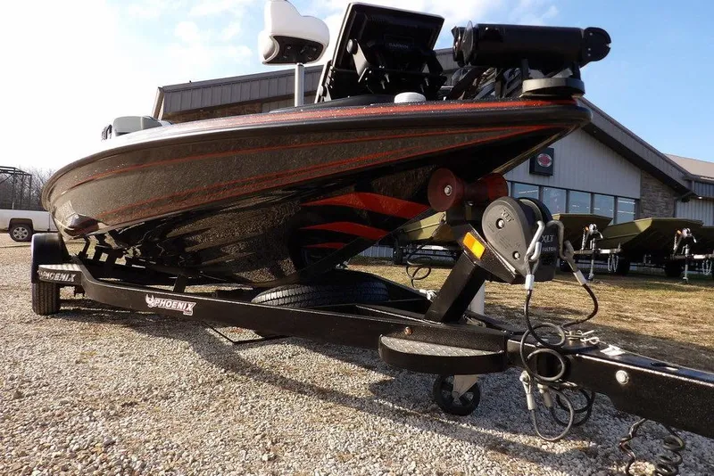 Slide: The Image of 2024 Phoenix 721 ProXP boat on trailer, displayed outdoors near a building. - 41