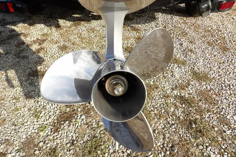 Slide: The Image of 2024 Phoenix 721 ProXP boat propeller on gravel surface. - 45