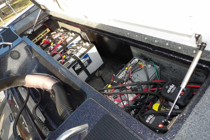 Slide: The Image of 2024 Phoenix 721 ProXP boat battery compartment with multiple batteries and wiring. - 46