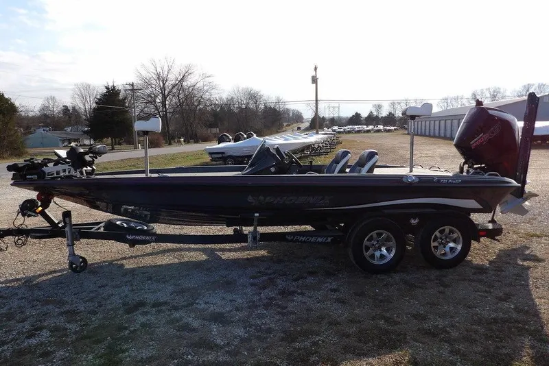 Slide: The Image of 2024 Phoenix 721 ProXP bass boat on trailer, parked outdoors. - 5