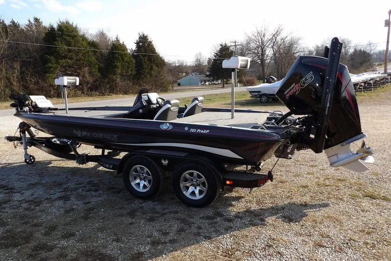 Slide: The Image of 2024 Phoenix 721 ProXP bass boat with dual console and powerful outboard motor. - 6