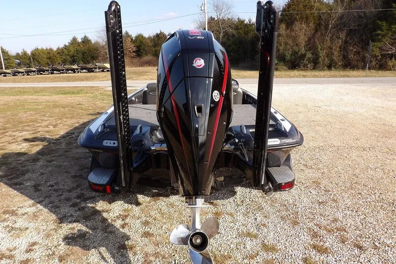 Slide: The Image of 2024 Phoenix 721 ProXP boat with powerful outboard motor, parked on gravel. - 8