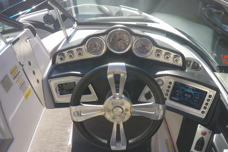 Slide: The Image of 2017 MasterCraft X10 boat dashboard with steering wheel and control gauges. - 3