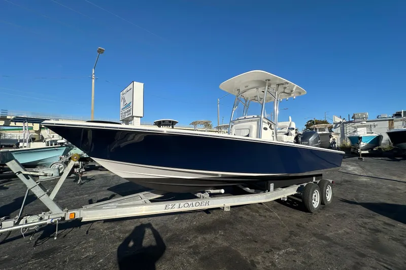 The Image of 2013 Sportsman Masters 247 Bay Boat on trailer, displayed outdoors under clear blue sky. - 0