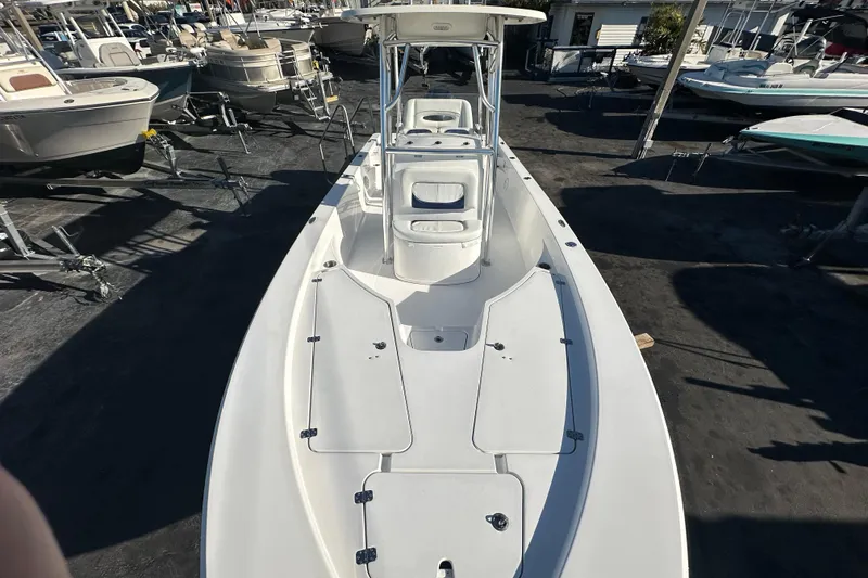 Slide: The Image of 2013 Sportsman Masters 247 Bay Boat, white, docked among other boats. - 11