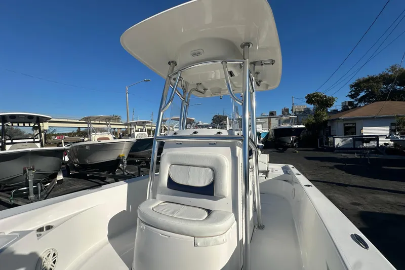 Slide: The Image of 2013 Sportsman Masters 247 Bay Boat with T-top, parked in a marina under clear blue sky. - 12