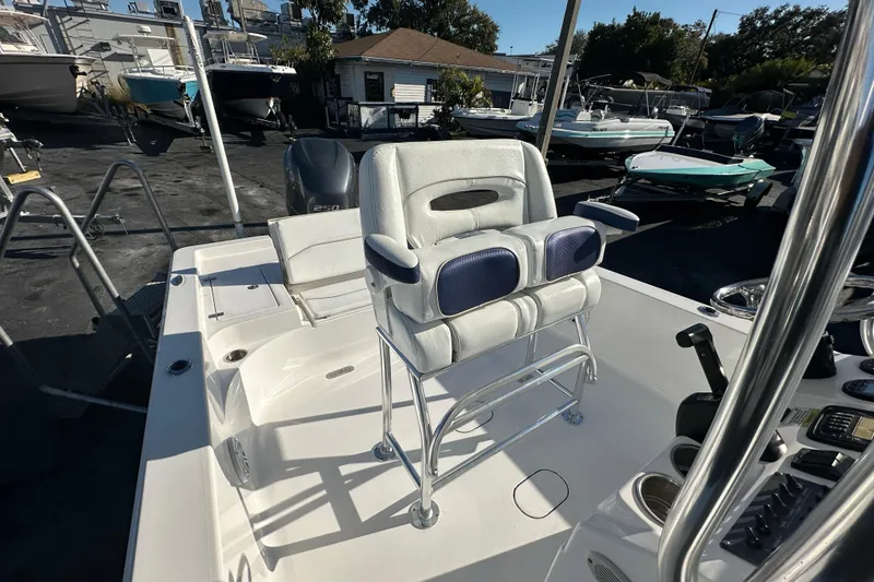 Slide: The Image of 2013 Sportsman Masters 247 Bay Boat with cushioned seating and console, parked in a marina. - 13