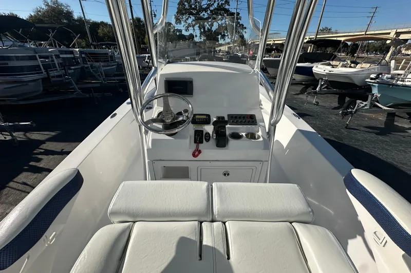 Slide: The Image of 2013 Sportsman Masters 247 Bay Boat cockpit with steering wheel and control panel. - 16