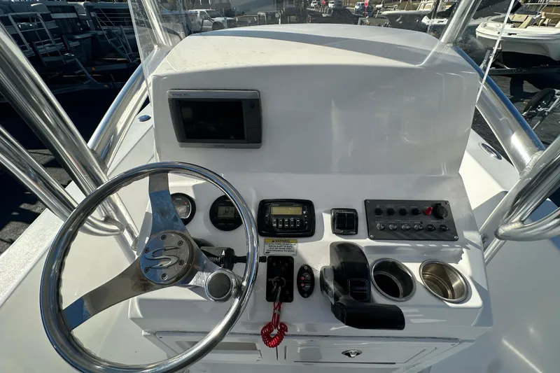 Slide: The Image of 2013 Sportsman Masters 247 Bay Boat console with steering wheel and controls. - 17