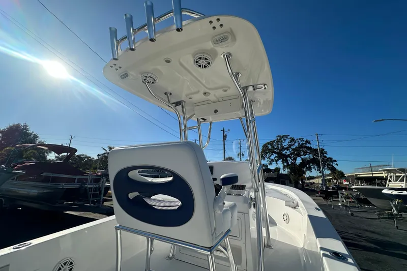 Slide: The Image of 2013 Sportsman Masters 247 Bay Boat with T-top and seating, under clear blue sky. - 19