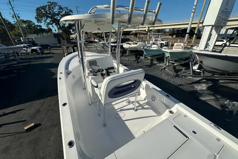 Slide: The Image of 2013 Sportsman Masters 247 Bay Boat in a marina, showcasing sleek design and spacious deck. - 23