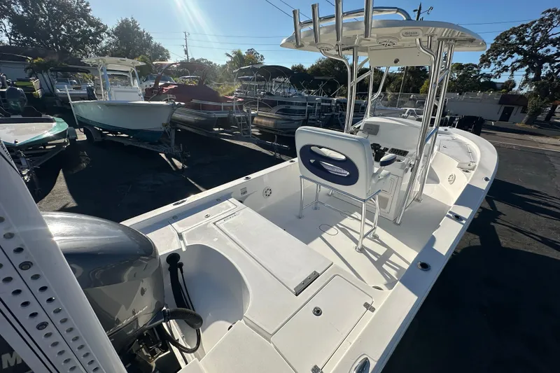 Slide: The Image of 2013 Sportsman Masters 247 Bay Boat with T-top and seating, parked outdoors. - 24