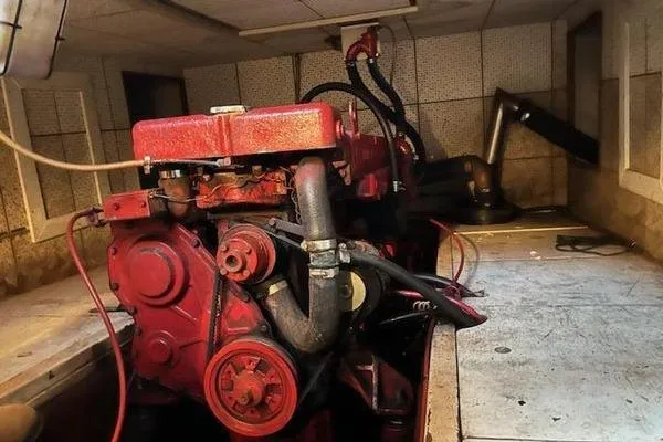 Slide: The Image of Engine room of a 1981 Marine Trader trunk cabin trawler with a red engine. - 12