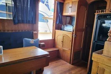 Slide: The Image of 1981 Marine Trader trunk cabin trawler interior with wooden furnishings and nautical decor. - 13