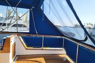 Slide: The Image of 1981 Marine Trader trunk cabin trawler with blue canopy and wooden deck. - 3