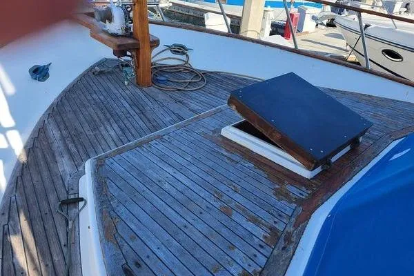 Slide: The Image of 1981 Marine Trader trunk cabin trawler deck with wooden finish and open hatch. - 4