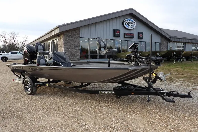 The Image of 2026 Crestliner XFC 189 fishing boat on trailer outside marine center. - 1