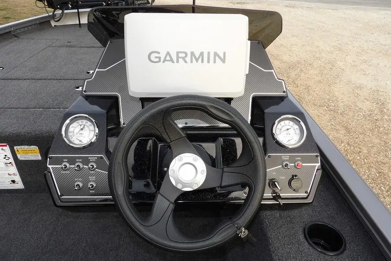 Slide: The Image of 2026 Crestliner XFC 189 boat dashboard with Garmin display and steering wheel. - 15