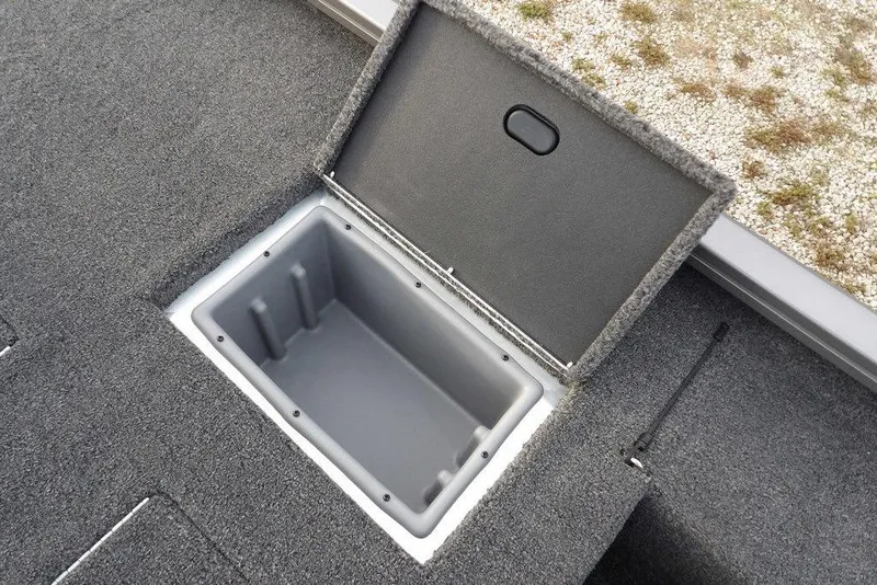 Slide: The Image of Open storage compartment on 2026 Crestliner XFC 189 boat, featuring carpeted interior. - 19