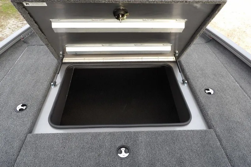 Slide: The Image of 2026 Crestliner XFC 189 boat storage compartment with open lid, showcasing interior space. - 27