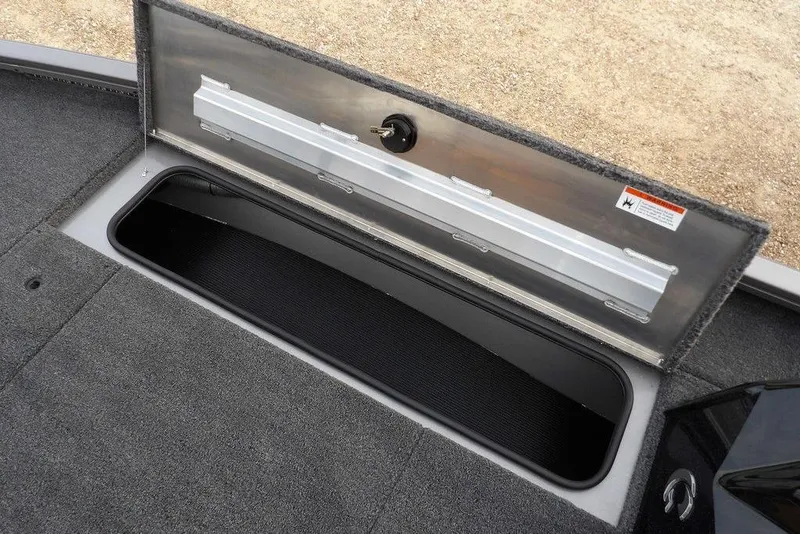 Slide: The Image of Open storage compartment in 2026 Crestliner XFC 189 boat, featuring carpeted interior. - 38