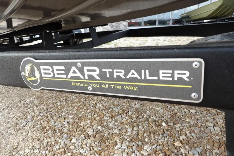 Slide: The Image of Bear Trailer logo on a Crestliner XFC 189, 2026 model, parked on gravel. - 47