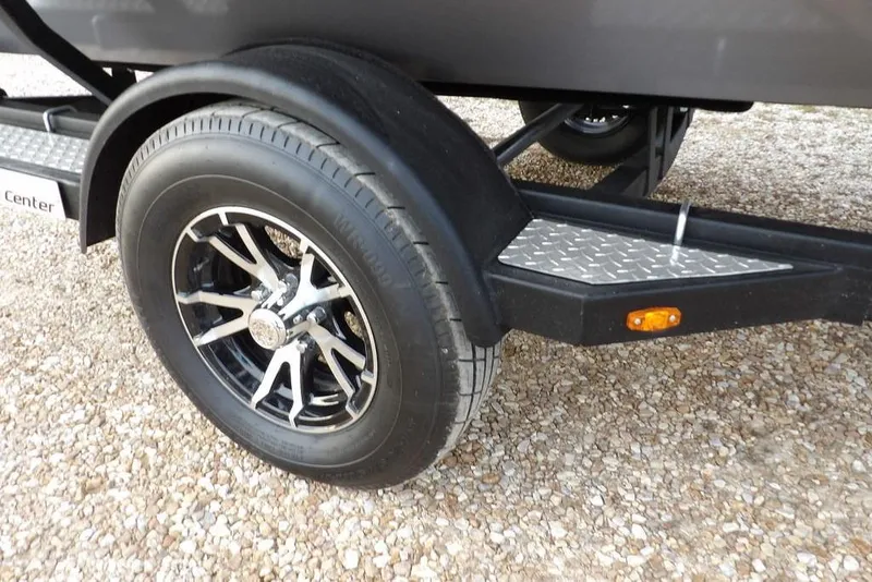 Slide: The Image of 2026 Crestliner XFC 189 trailer wheel with stylish alloy rim on gravel. - 48