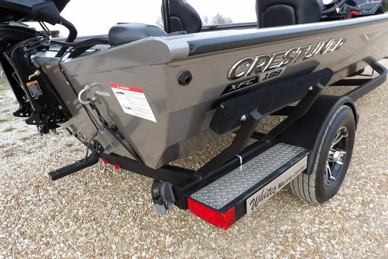Slide: The Image of 2026 Crestliner XFC 189 boat on trailer, rear view, parked on gravel. - 50