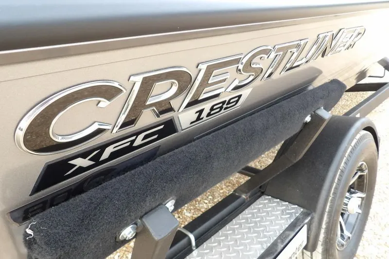Slide: The Image of 2026 Crestliner XFC 189 boat logo on trailer, showcasing sleek design and branding. - 51