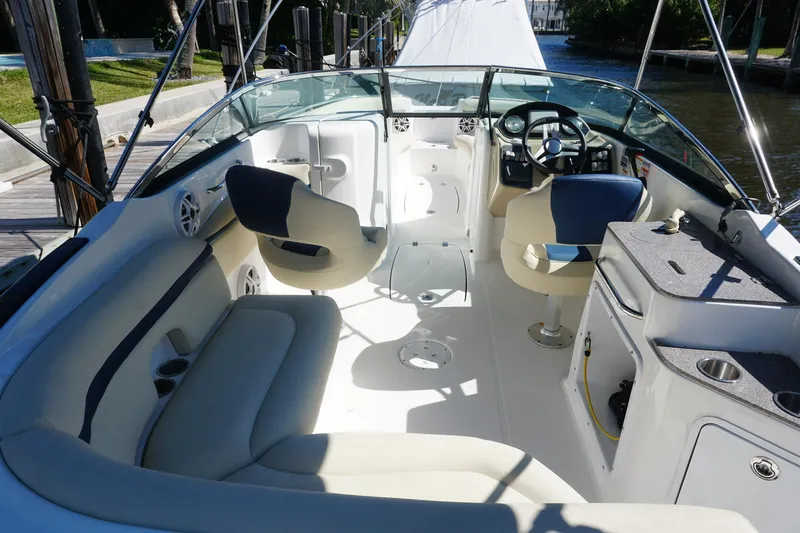 Slide: The Image of 2018 Hurricane SunDeck 2400 OB boat interior with seating and steering console. - 8
