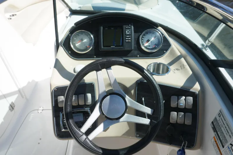 Slide: The Image of 2018 Hurricane SunDeck 2400 OB boat dashboard with steering wheel and gauges. - 9