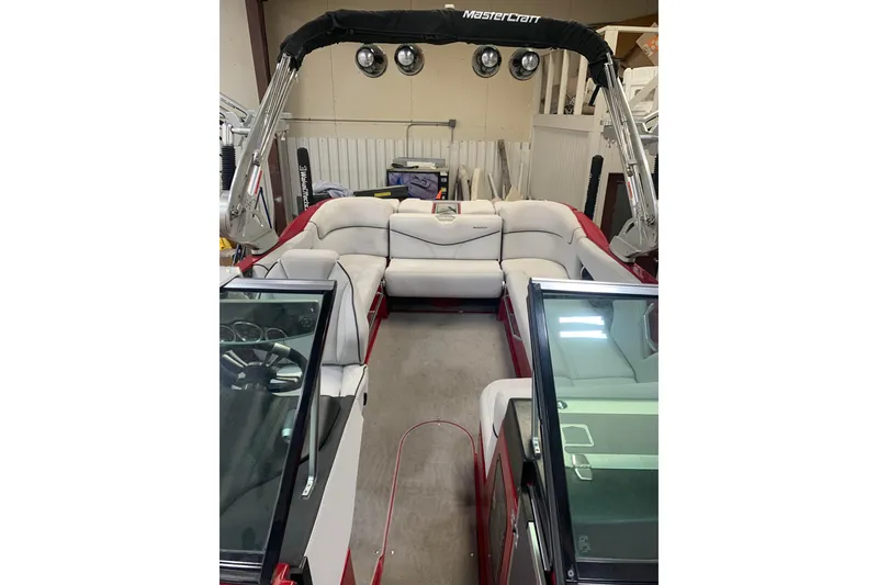 Slide: The Image of 2017 MasterCraft X23 boat interior with white seating and black canopy. - 4