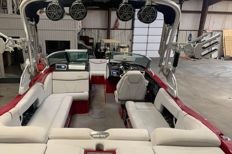 Slide: The Image of 2017 MasterCraft X23 boat interior with white seating and advanced audio system. - 5