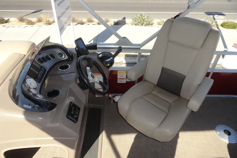 Slide: The Image of 2022 Sun Tracker Fishin' Barge 20 DLX helm with comfortable captain's chair and control panel. - 11