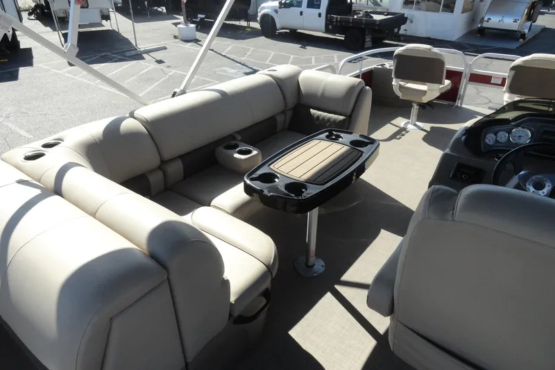 Slide: The Image of 2022 Sun Tracker Fishin' Barge 20 DLX interior with beige seating and table. - 13