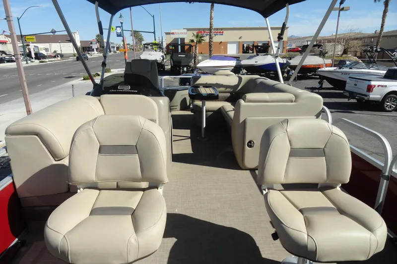 Slide: The Image of 2022 Sun Tracker Fishin' Barge 20 DLX interior with beige seating and canopy. - 17