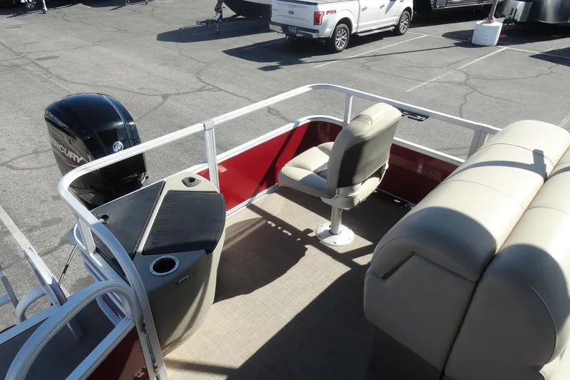 Slide: The Image of 2022 Sun Tracker Fishin' Barge 20 DLX interior with seating and Mercury outboard motor. - 20
