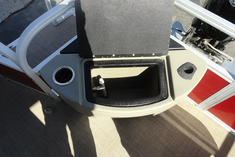 Slide: The Image of 2022 Sun Tracker Fishin' Barge 20 DLX storage compartment with cup holder and motor view. - 21