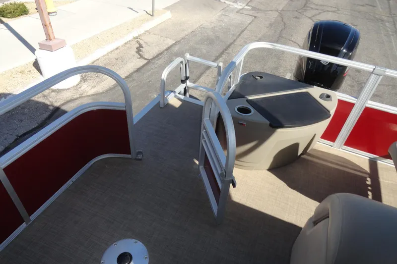 Slide: The Image of 2022 Sun Tracker Fishin' Barge 20 DLX pontoon boat deck with motor and seating. - 22