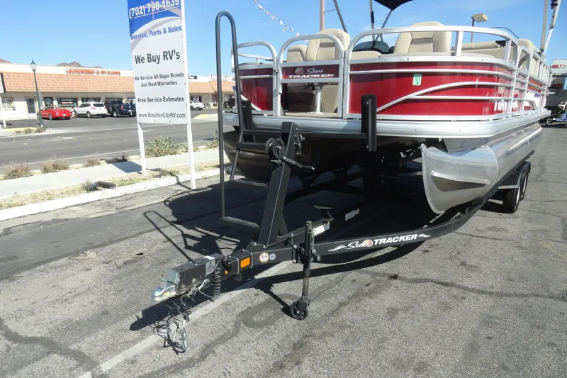 Slide: The Image of 2022 Sun Tracker Fishin' Barge 20 DLX pontoon boat on trailer in parking lot. - 23