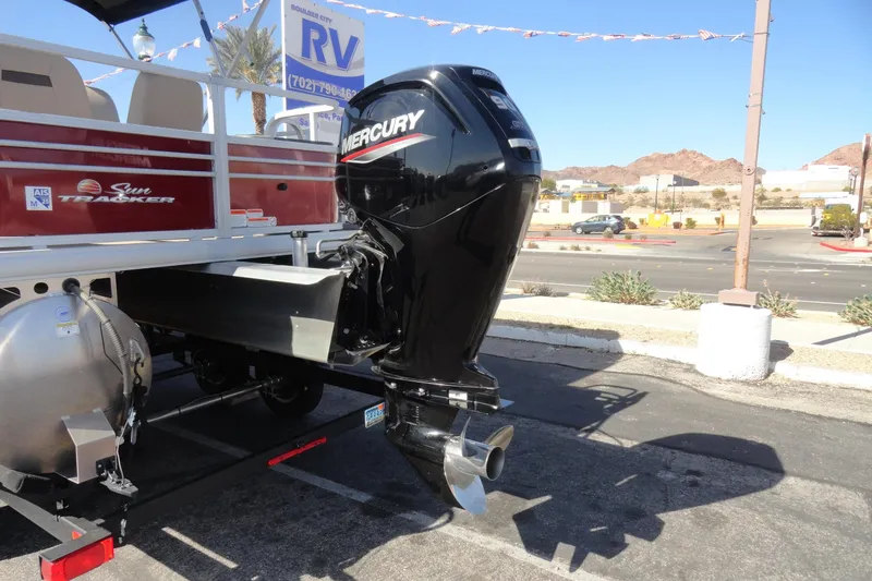 Slide: The Image of 2022 Sun Tracker Fishin' Barge 20 DLX with Mercury outboard motor in parking lot. - 25